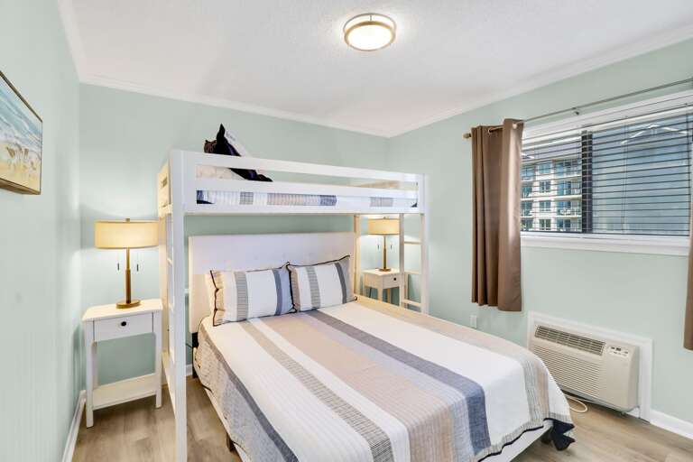 The newly renovated guest bedroom has a queen size bed and a twin bunk bed combination.