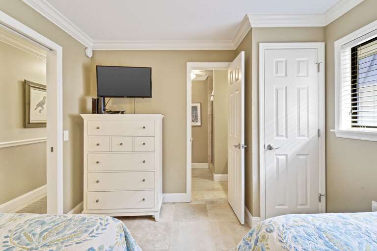 Plenty of storage and flat screen TV in this guest room.  Connects to the 2nd bathroom. 