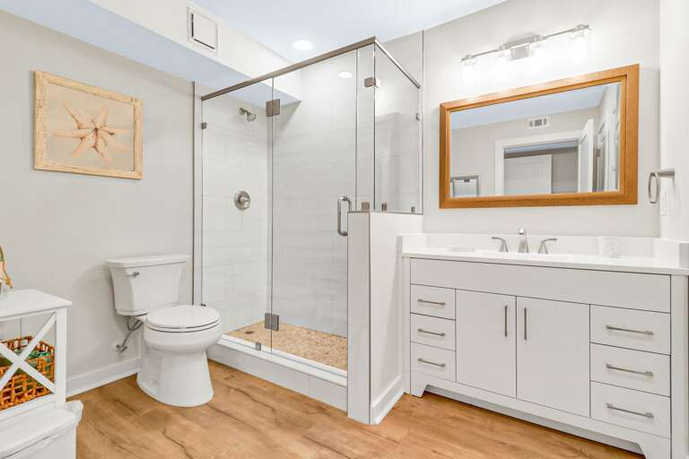 Beautiful newly renovated master bathroom with tiled, walk-in shower and plenty of storage. 