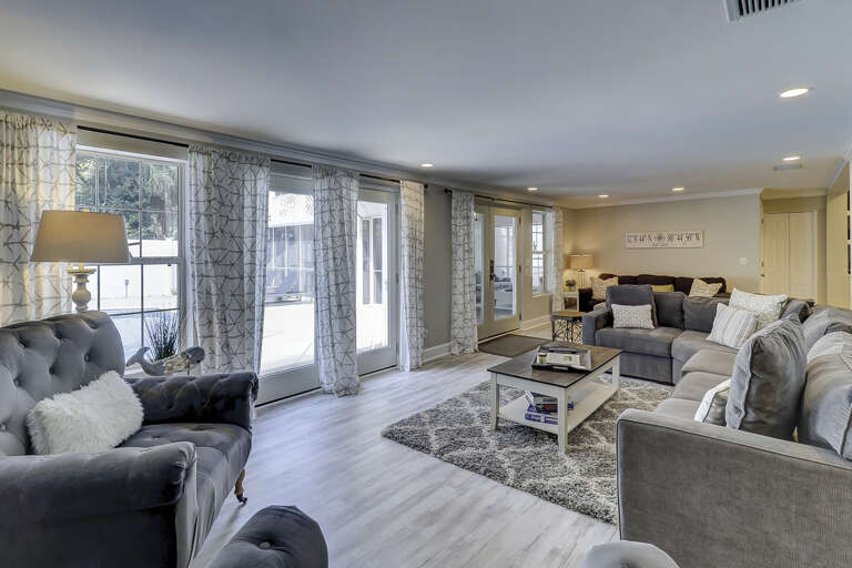 Spacious living room area with flat screen TV and sleep sofa bed by far wall.  Spacious living room area with flat screen TV and sleep sofa bed by far wall.