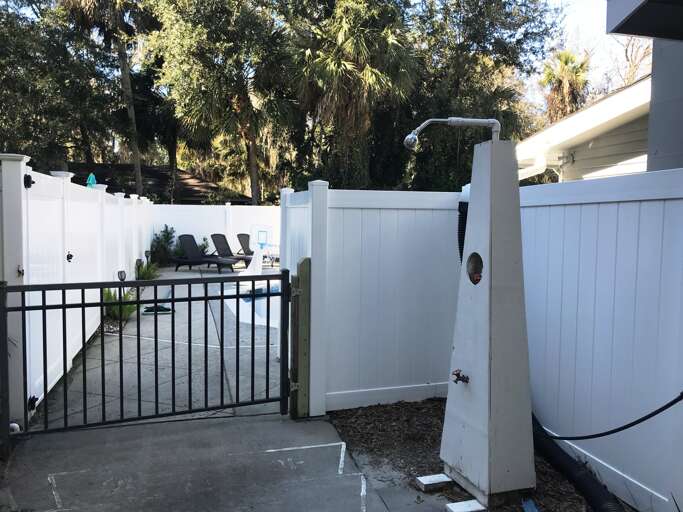 SIde yard pool and back yard entrance with outside beach shower before entering the pool. SIde yard pool and back yard entrance with outside beach shower before entering the pool.