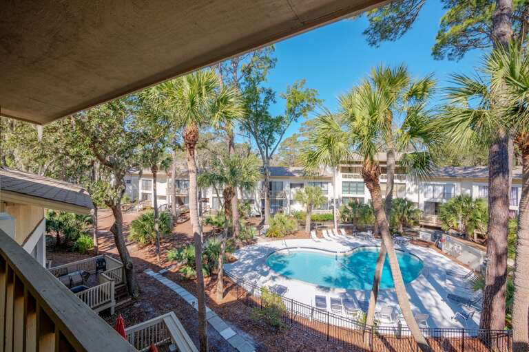 Balcony view of palm trees and pool .. enjoy and just relax !