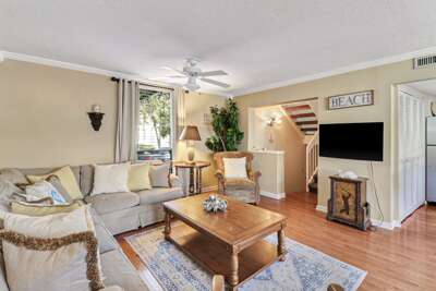 Living Room Interior With Staircase And TV In Vacation Rental