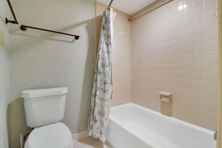 Shower tub combination in this newly painted bathroom 