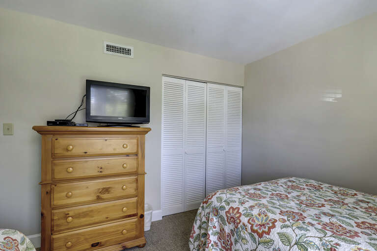flat screen TV and large closet with 2 queen beds
