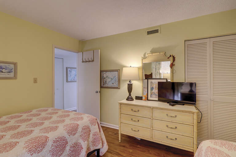 Guest room with flat screen TV and closet space. 