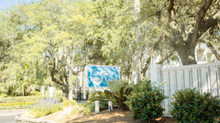 Sunlight Setting On Scenic Seaside Vacation Rental Sign
