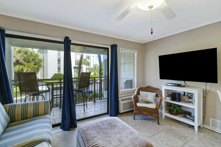 Living Room With Television And Balcony Access Living Room With Television And Balcony Access