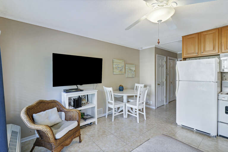 Interior Of A Residential Living Room With Kitchen Appliances And Dining Area Interior Of A Residential Living Room With Kitchen Appliances And Dining Area