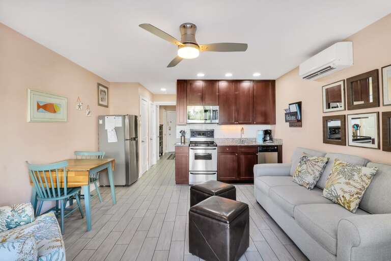Interior View Of A Living Area With Kitchen, Sofa, And Dining Table Interior View Of A Living Area With Kitchen, Sofa, And Dining Table