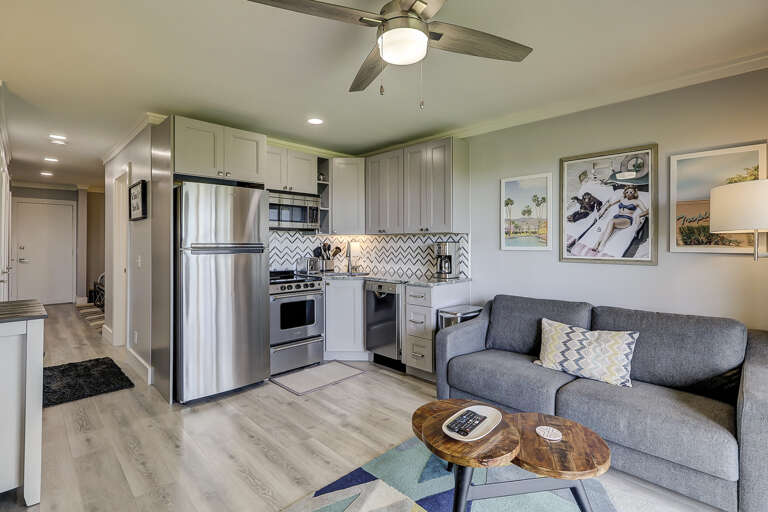 The main living area in this condo with all brand new furnishings include the all stainless and granite kitchen, wood grain tile floors and new wood cabinets. The living room area has a new sofa w/queen sleeper. The room opens to the balcony overlooking t