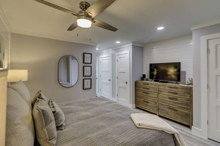 The new renovation at this condo has an open concept allowing the decorator the space to build two closets and install a king sized bed.