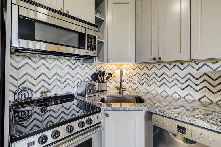 The kitchen is fully equipped with new stainless appliances, glass top range, granite counters and tile backsplash. The kitchen is fully equipped with new stainless appliances, glass top range, granite counters and tile backsplash.