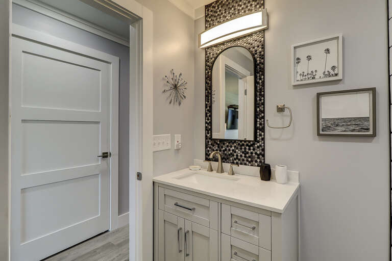 The marble topped sink and vanity has storage space under. The marble topped sink and vanity has storage space under.