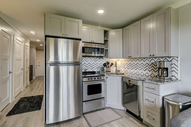 All new stainless appliances, granite counters, tile backsplash and wood cabinets make up the fully equipped kitchen.  Wood grain tile flooring is throughout the condo.