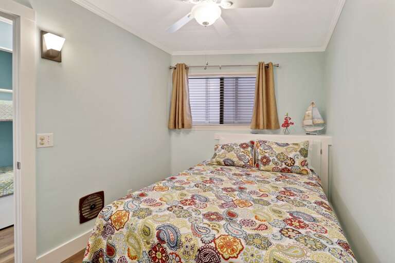Bedroom has queen sized bed with ceiling fan and 4 drawer dresser.   Bedroom has queen sized bed with ceiling fan and 4 drawer dresser.