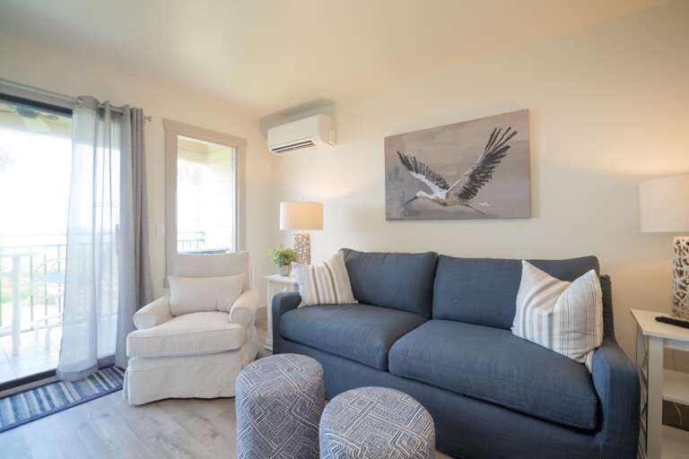 Living Room Interior With Sofa, Armchair, And Wall Art