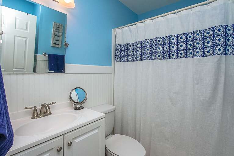 Nicely remodeled bathroom has a marble top vanity, new cabinet and a tub/shower combination.