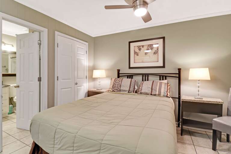 queen sized bed with ceiling fan for a restful sleep.  