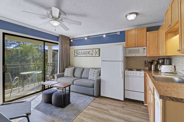 Interior View Of A Living Space With Kitchenette And Balcony Access