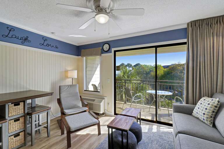 Interior Of A Room With Furniture And A Balcony View