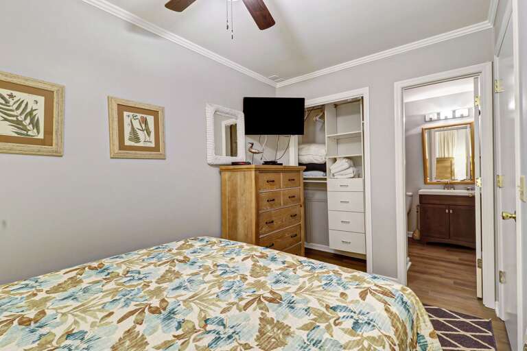 Ceiling fan and lots of storage in this queen sized bedroom with new paint and bedding. . 