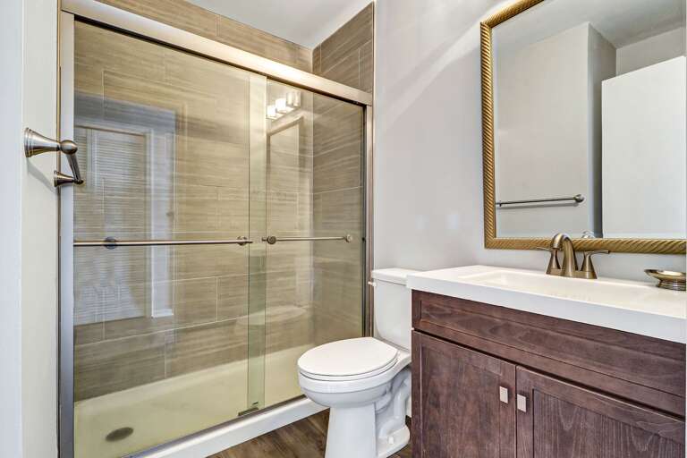 Lovely updated bathroom with walk-in shower and new vanity. 