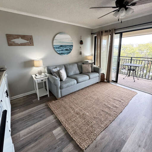 Interior Living Space With Sofa And Balcony Access