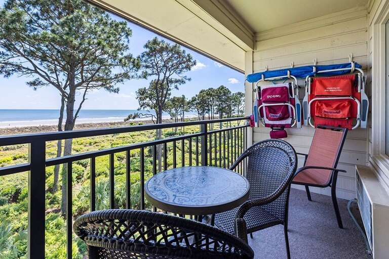 Beachfront Balcony View With Chairs And Table