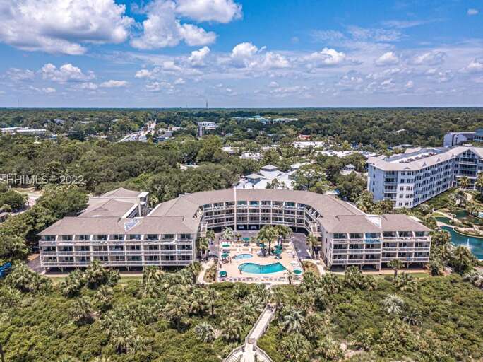 Aerial View Of A Large Building Complex With Central Pool Surrounded By Greenery