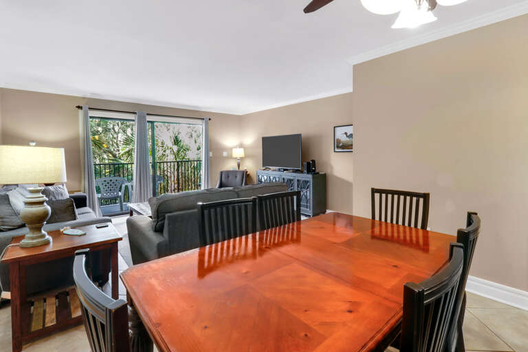 Interior View Showing A Dining Table And Living Room Area With A Balcony