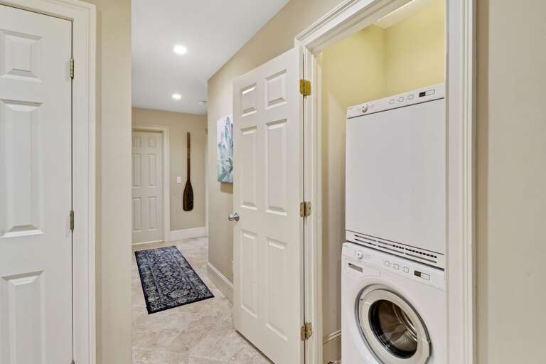 Easy to wash all those towels and clothes after a fun day at the beach in this stackable washer/dryer combination located in the hallway. 