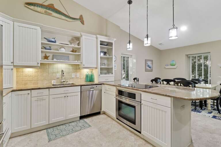 Kitchen peninsula has 3 barstools and easy access to dining area.  