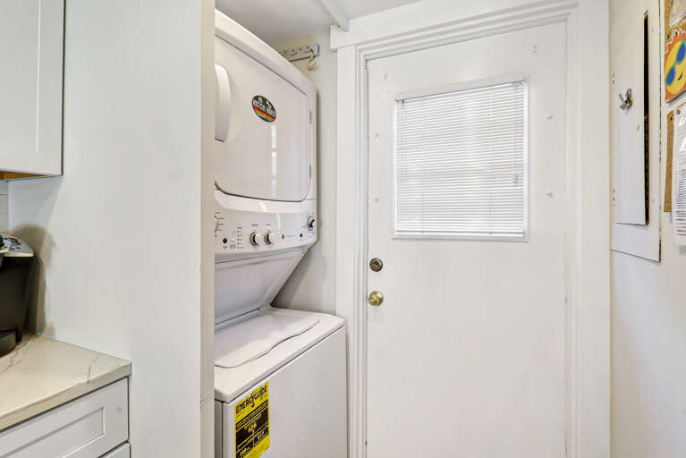 This unit is equipped with a stacked washer and dryer.