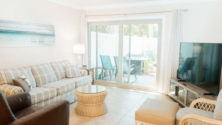 This bright and airy living/dining area offers the perfect blend of comfort and coastal charm. The living room features plush seating, stylish beach-themed décor, and large windows/sliding doors that fill the space with natural light. The dining area comf This bright and airy living/dining area offers the perfect blend of comfort and coastal charm. The living room features plush seating, stylish beach-themed décor, and large windows/sliding doors that fill the space with natural light. The dining area comf