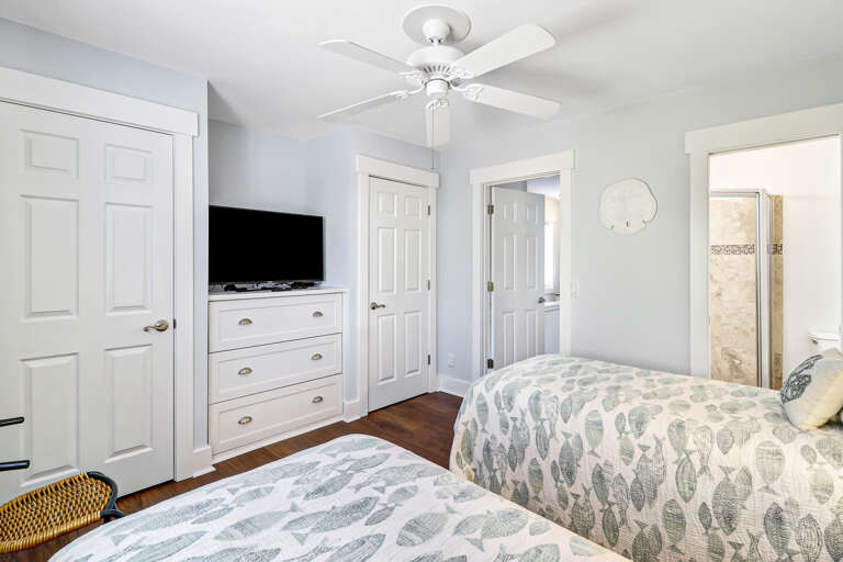 This cute guest bedroom sleeps two comfortably with plenty of space in the closets to store luggage and clothing.