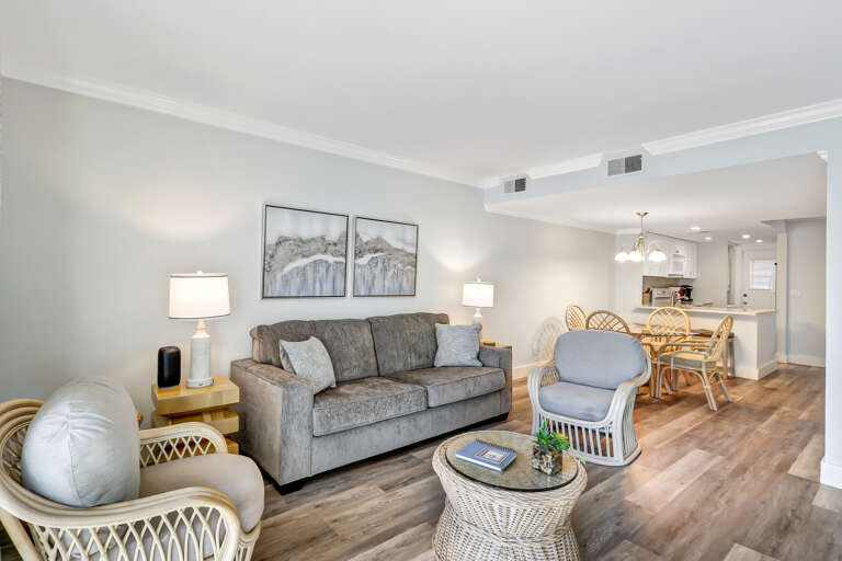  The living room has a comfy sofa bed, wall mounted smart flat screen T.V. and sliding door to balcony with amazing Beachfront view and Palm trees.