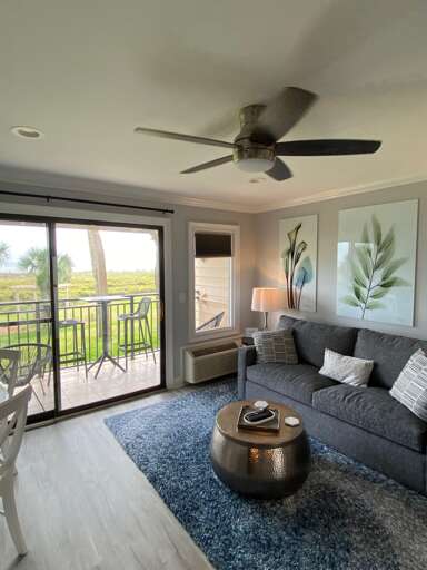 Living Room With Sofa And Balcony View In A Vacation Rental Living Room With Sofa And Balcony View In A Vacation Rental