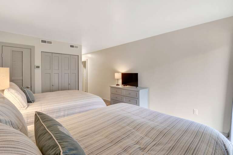 Relax and enjoy TV in this 3rd bedroom with 2 queen sized beds. 