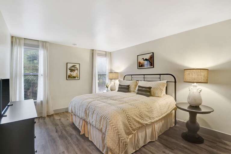 King sized bed in this comfortable renovated 2nd bedroom with plenty of light and flat screen TV.  