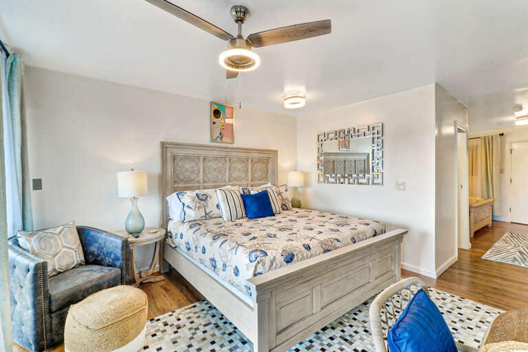 Bedroom Interior In Vacation Rental With Queen Bed And Ceiling Fan
