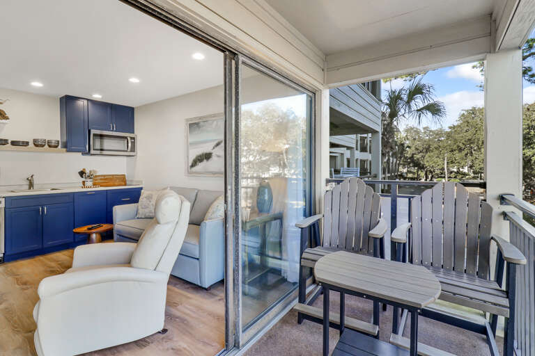 Interior Living Space With Kitchen And Balcony Access