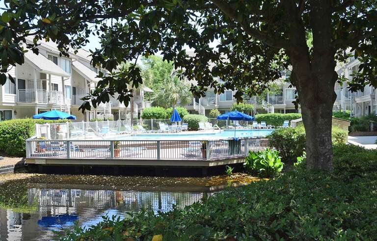 Vacation Rental Complex With Outdoor Pool And Foliage