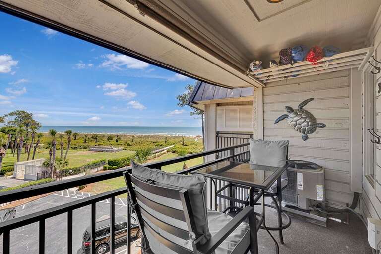 Balcony With Chairs Overlooking Sea And Park