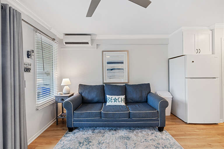 Interior Living Area With Sofa, Rug, And Kitchen Appliances