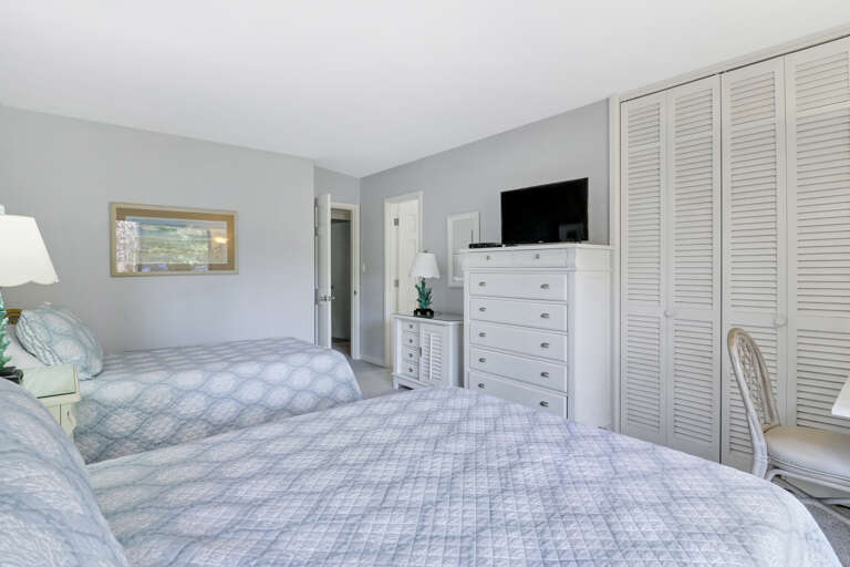 Vacation Rental Room With Twin Beds, White Dresser, Television