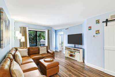 Comfortable seating with a large screen TV in the living room.