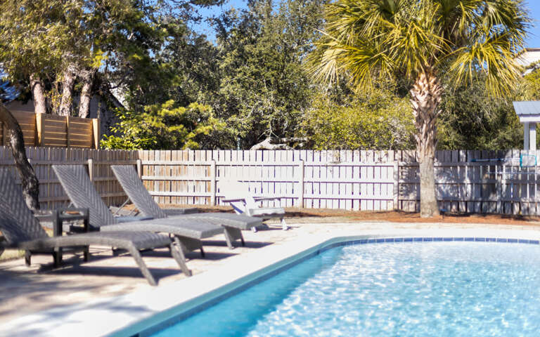 Dive into your private oasis where sparkling blue waters await beneath swaying palms and sunny skies.