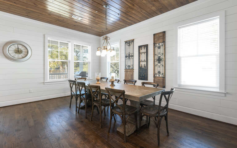 Gather around this beautiful farmhouse dining table where your group can share memorable meals beneath the stunning wood ceiling.
