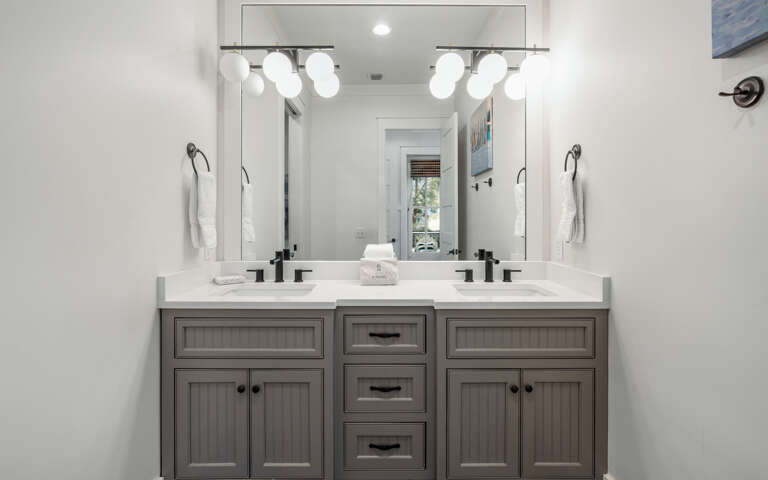 Your private bathroom features dual vanities with premium lighting and storage for a relaxing morning routine.